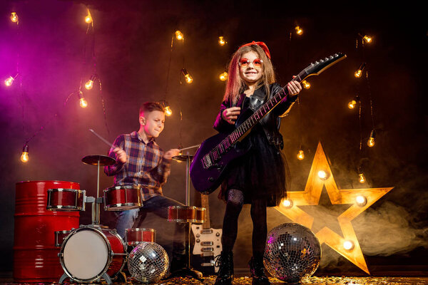 Kids pretending to be in a rock band