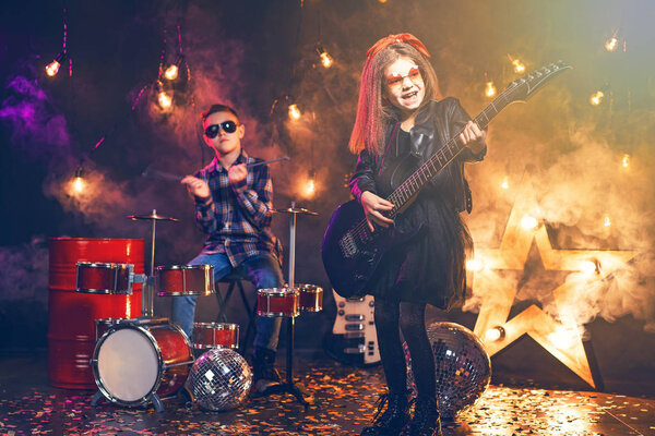 Kids pretending to be in a rock band