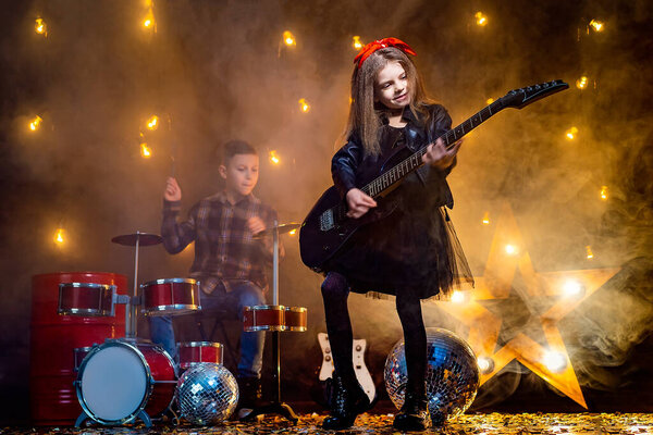 Kids pretending to be in a rock band