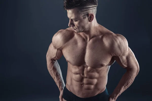 Stark atletisk sexig muskulös man på svart bakgrund — Stockfoto