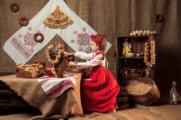 Adorable girl pouring tea from samovar — Stock Photo, Image
