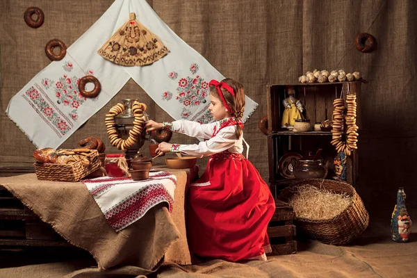 Adorável menina derramando chá de samovar — Fotografia de Stock