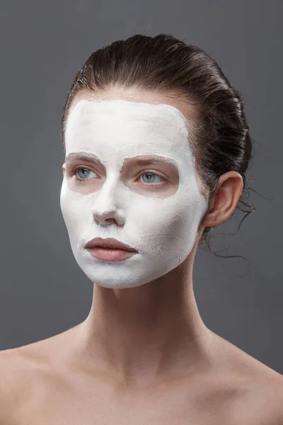 Beautiful girl is applied a white cosmetic mask from black dots. Isolate, studio — Stock Photo, Image