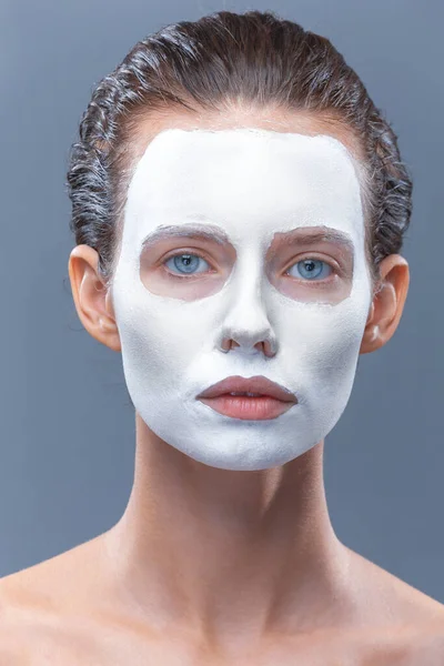 Beautiful girl is applied a white cosmetic mask from black dots. Isolate, studio — Stock Photo, Image