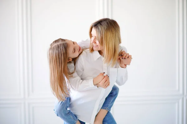 Portrait of little girl loving mother and holding her — Stock Photo, Image