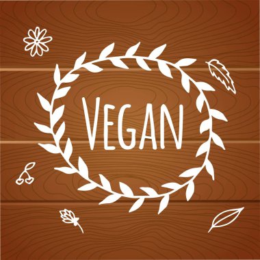 Vegan ürün etiketi. Dünya vejetaryen günü. El çekilmiş rustik çerçeve çiçek ve yaprakları üzerine tahta arka plan ile. Tipografi tasarımı. Vegan.