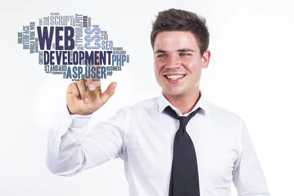 Веб-розробка - молодий бізнесмен торкається хмари слів — стокове фото