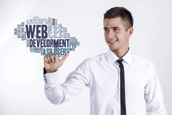 Web development - Young businessman touching word cloud — Stock Photo, Image