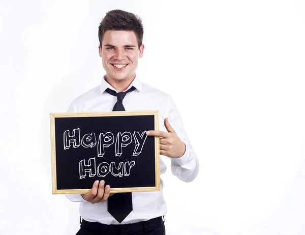Happy Hour - Young smiling businessman holding chalkboard with t — Stock Photo, Image