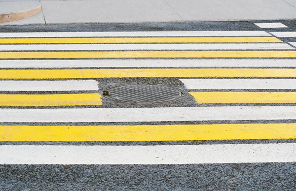 Pedestrian crossing road crossing with white and yellow stripes