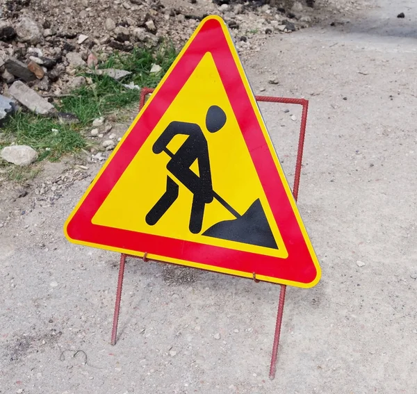 Road works sign for construction works in street at the site of repairs