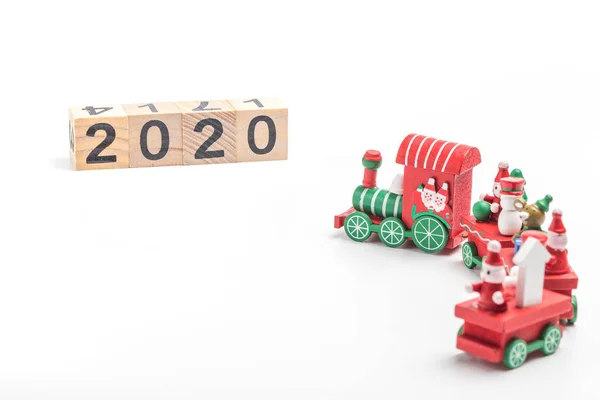 The toy train on the desk and the building block with the word 2020
