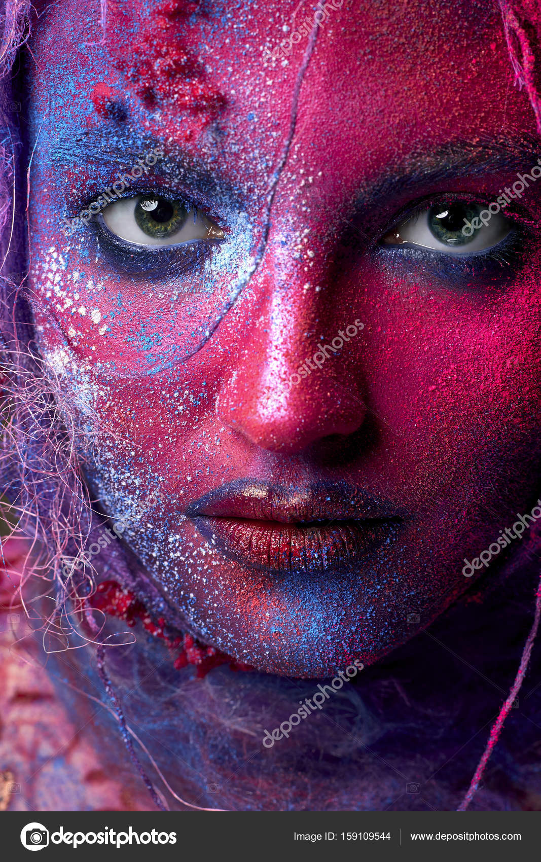 Female face art with creative make up. Closeup cropped studio portrait