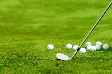 Golf sopası ve toplar çimen kopyalama alanında
