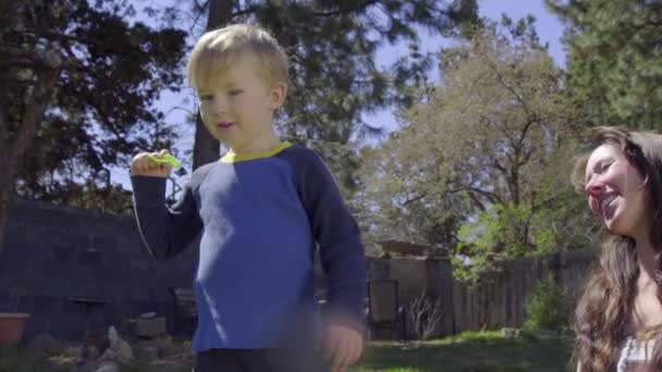 Adorable little attempts to blow a bubble — Stock Video