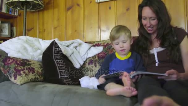 Mother reading a book to son — Stock Video