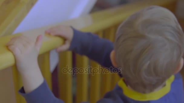 Boy as climbs down a staircase — Stock Video