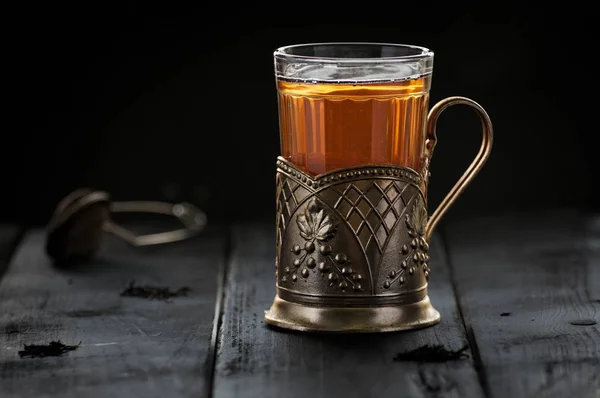 Traditional Russian tea served in glass with vintage brass glass