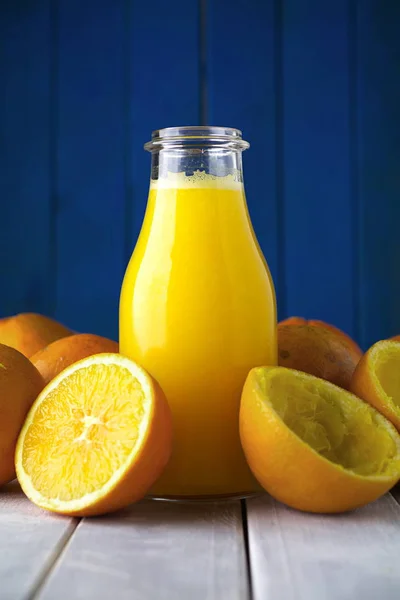 Freshly squeezed natural organic orange juice in bottle with ora