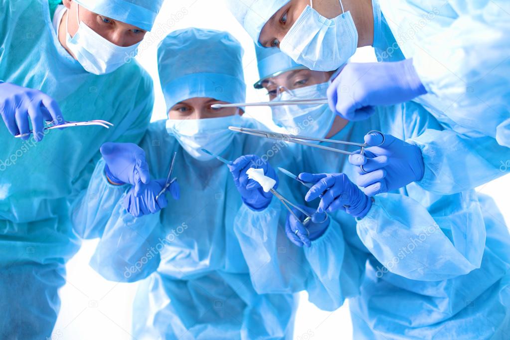 Team of surgeon in uniform perform operation on a patient at cardiac
