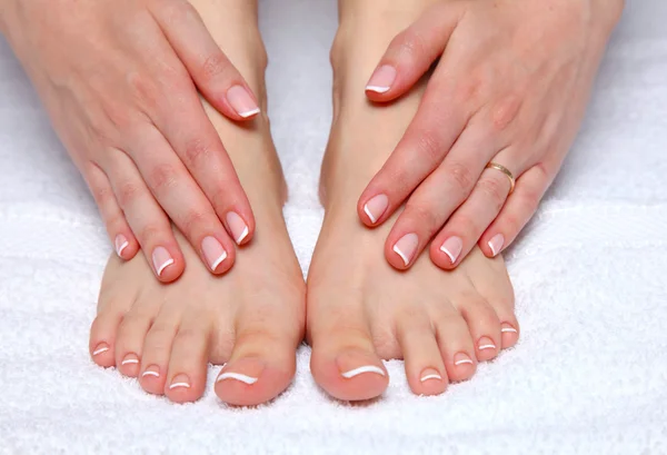 Closeup photo of a beautiful female feet with red pedicure isolated on white — Stock Photo, Image