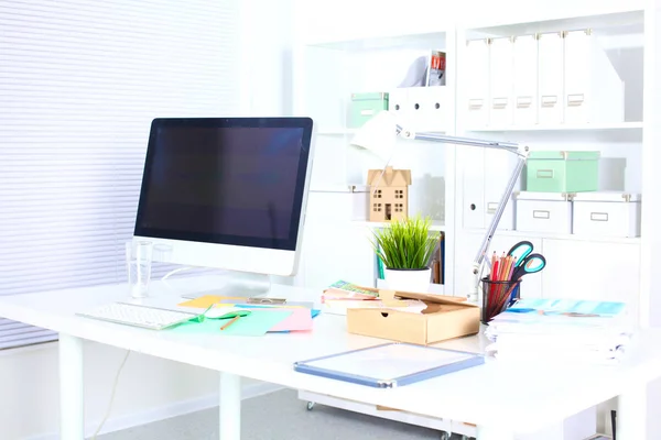 office working desk with computer and paperwork