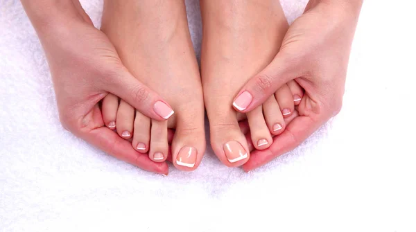 Closeup photo of a beautiful female feet with red pedicure isolated on white — Stock Photo, Image
