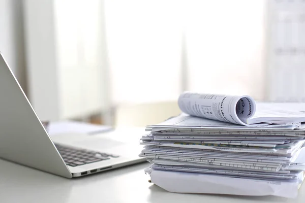 stock image Laptop with stack of folders on table  white background