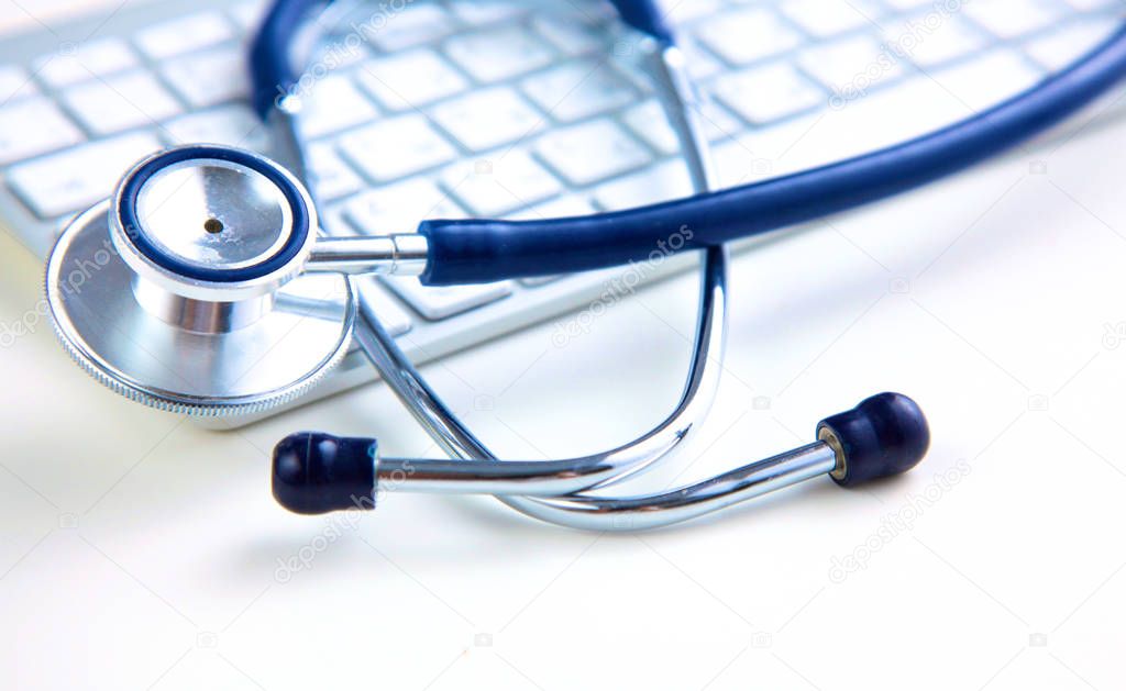 medical stethoscope near  laptop on  wooden table,  white