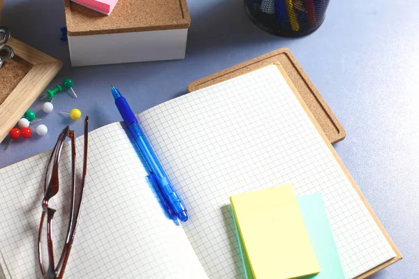 office desk with papers and headphones