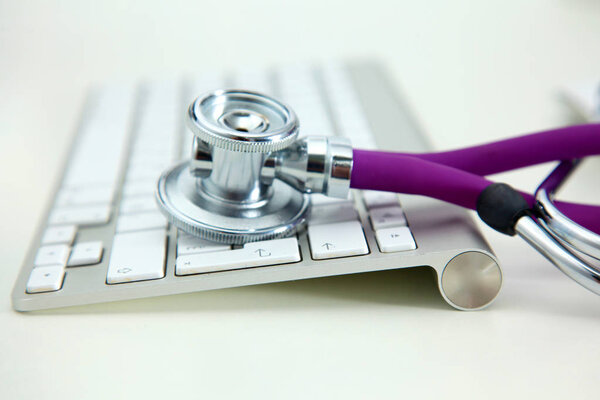 Stethoscope lying on a table an open book