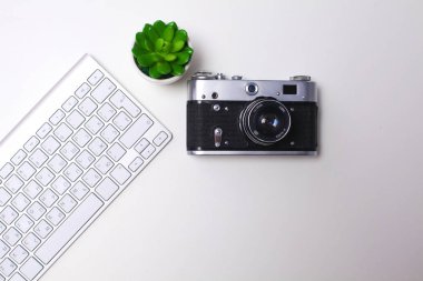 Beyaz masa üzerinde üstten görünüm office grafik tasarım kalem fare ile laptop kablosuz fare ve vintage eski fotoğraf makinesi. Kavram grafik tasarım iş yeri