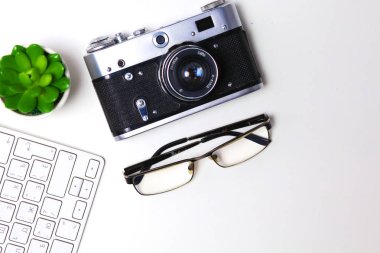 Beyaz masa üzerinde üstten görünüm office grafik tasarım kalem fare ile laptop kablosuz fare ve vintage eski fotoğraf makinesi. Kavram grafik tasarım iş yeri