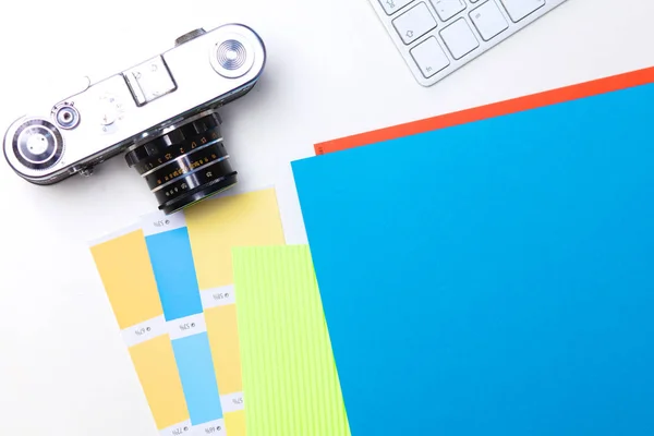 Top view of office graphic design pen mouse with laptop wireless mouse and vintage old camera on white table. Concept graphic design workplace