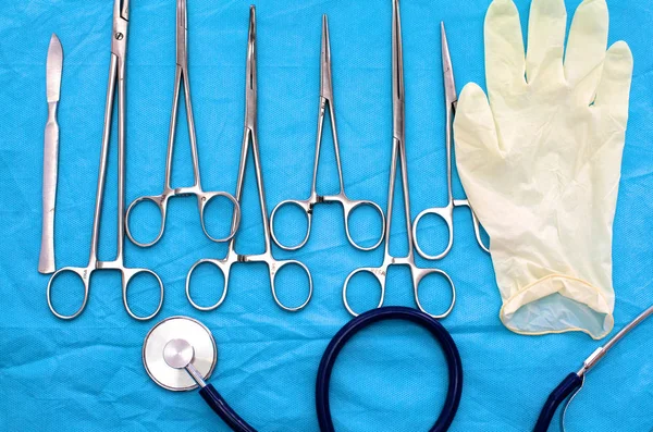 Surgical instruments and tools including scalpels, forceps and tweezers arranged on a table for a surgery — Stock Photo, Image