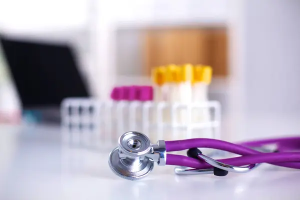 Stethoscope near medical tubes on white background — Stock Photo, Image