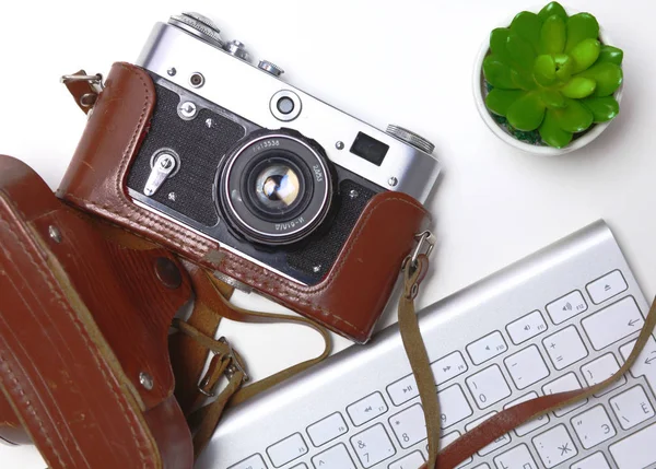 Top view of office graphic design pen mouse with laptop wireless mouse and vintage old camera on table