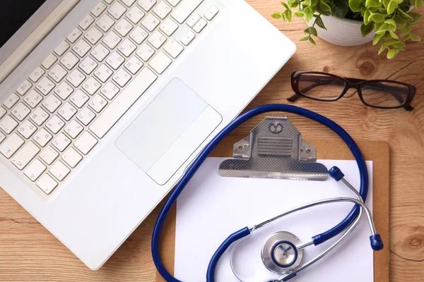 A medical stethoscope lies on the patients medical history on a computer background. The concept of medical care or insurance — Stock Photo, Image