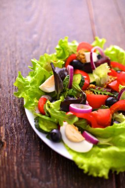 Tahta ve bulanık arka planda taze sebzeler.