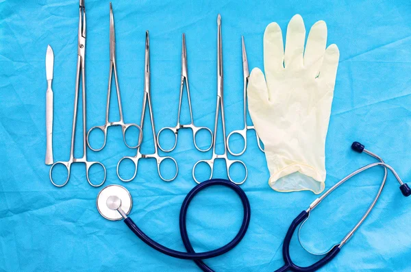 手术器械和工具，包括手术刀、钳和镊子，放在手术台上 — 图库照片