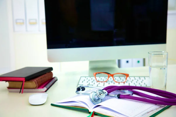 Stetoskop i komputer na biurku w biurze — Zdjęcie stockowe