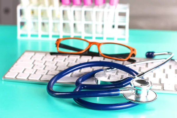 Doctors workspace working table with patients discharge blank paper form, medical prescription, stethoscope on desk