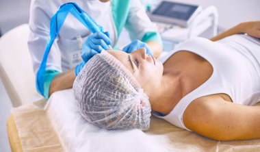 Kalıcı makyaj kaşları için. Güzellik Salonu içinde kalın kaşları ile güzel bir kadın. Şevval Özçelik Güzellik kadın yüzü için kaş dövme yapıyor. Güzellik yordamı