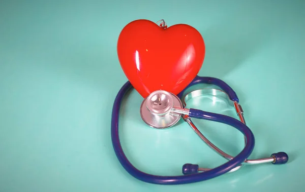 Red heart with stethoscope on blue wooden background. Copy space. Valentines day. — Stock Photo, Image