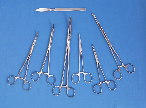 Chirurgische instrumenten en gereedschappen, met inbegrip van scalpels, tang en pincet op een tafel voor een operatie — Stockfoto