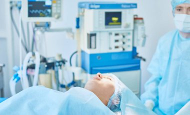 Birkaç doktor hasta operasyon masası üzerinde onların çalışma sırasında çevreleyen. Takım cerrahlar ameliyathane içinde işte
