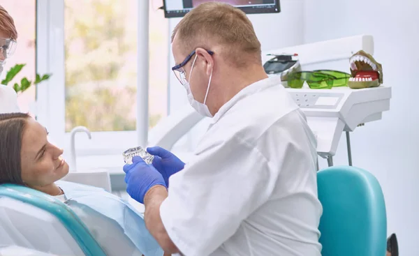 Doctor dentist treats teeth of a beautiful young girl patient. The girl on reception at the dentist. Doctor dentist treats tooth