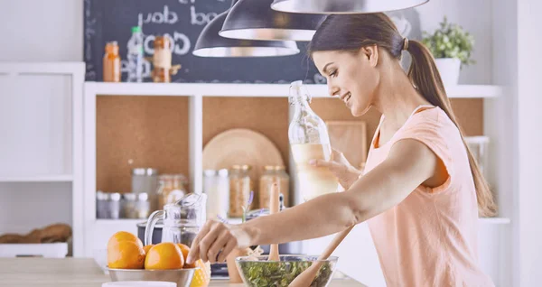 Happy young cook girl preparing food from greens — Stock Photo, Image