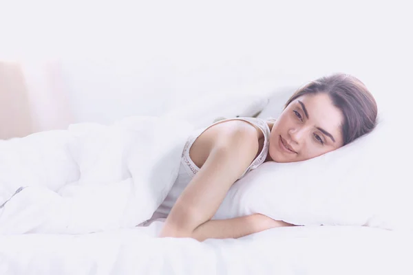 Beautiful young woman basking in bed in the morning. Beautiful — Stock Photo, Image