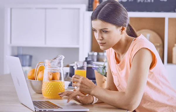 微笑着的漂亮女人看着手机, 拿着玻璃 — 图库照片